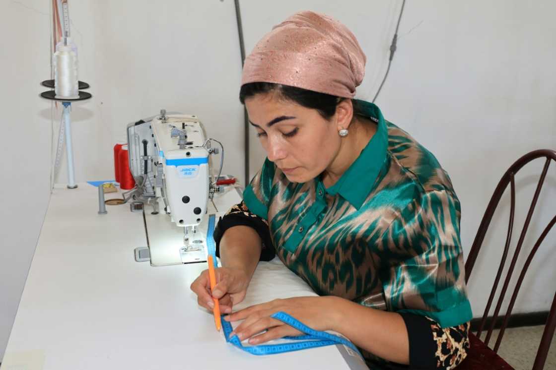 A seamstress works on a silk garment at a Tumush Kola factory in Uzbekistan A seamstress works on a silk garment at a Tumush Kola factory in Uzbekistan