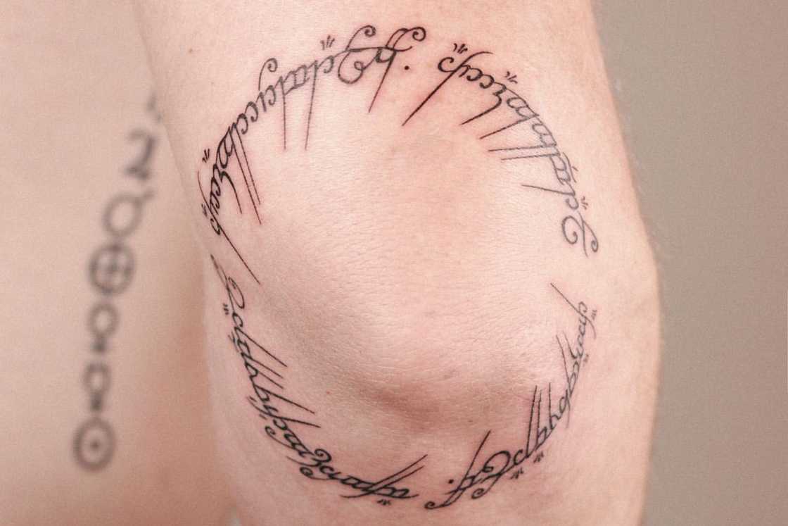 Script tattoo encircling an elbow Script tattoo encircling an elbow