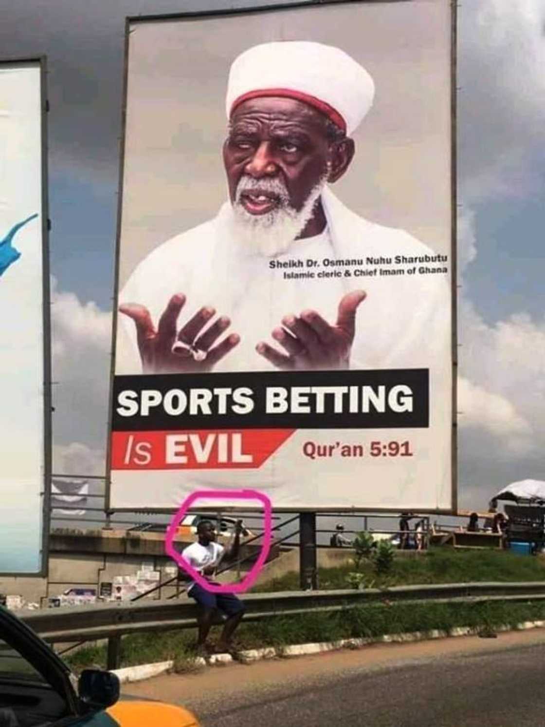 Man ‘defies’ Chief Imam and checks bet slip under billboard which says betting is evil (Photo)