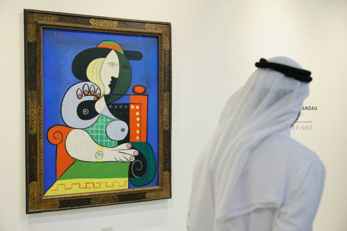 A visitor looks at Pablo Picasso's painting 'Femme a la montre' displayed for viewing at Sotheby’s Dubai, ahead of an auction in New York A visitor looks at Pablo Picasso's painting 'Femme a la montre' displayed for viewing at Sotheby’s Dubai, ahead of an auction in New York