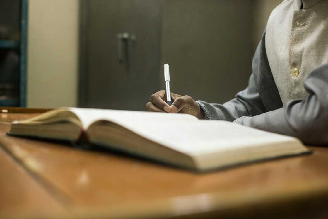 A man writing a journal A man writing a journal