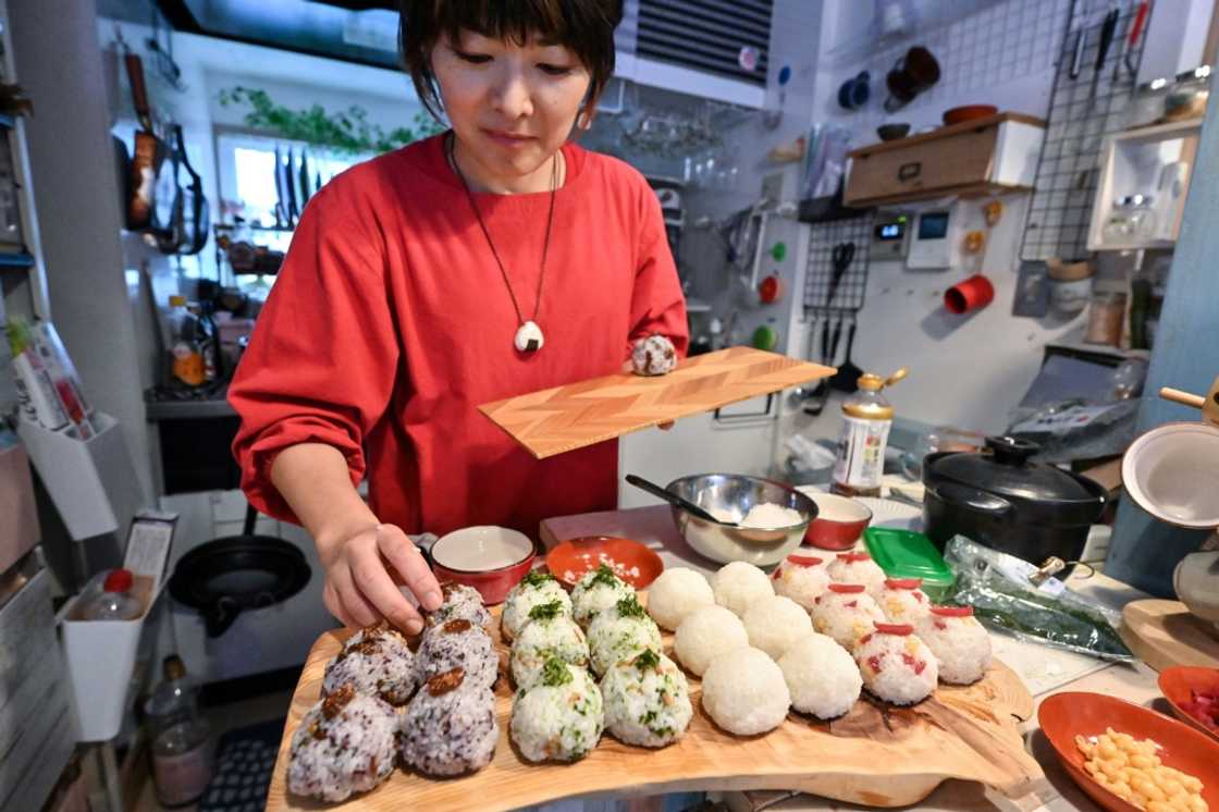 Miki Yamada prepares onigiri rice balls for her catering business at home in Tokyo Miki Yamada prepares onigiri rice balls for her catering business at home in Tokyo