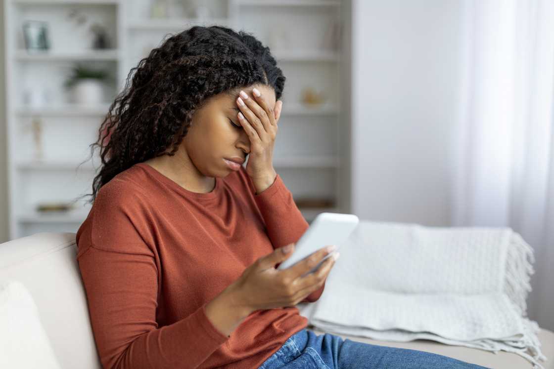A disappointed woman hodling a phone A disappointed woman hodling a phone