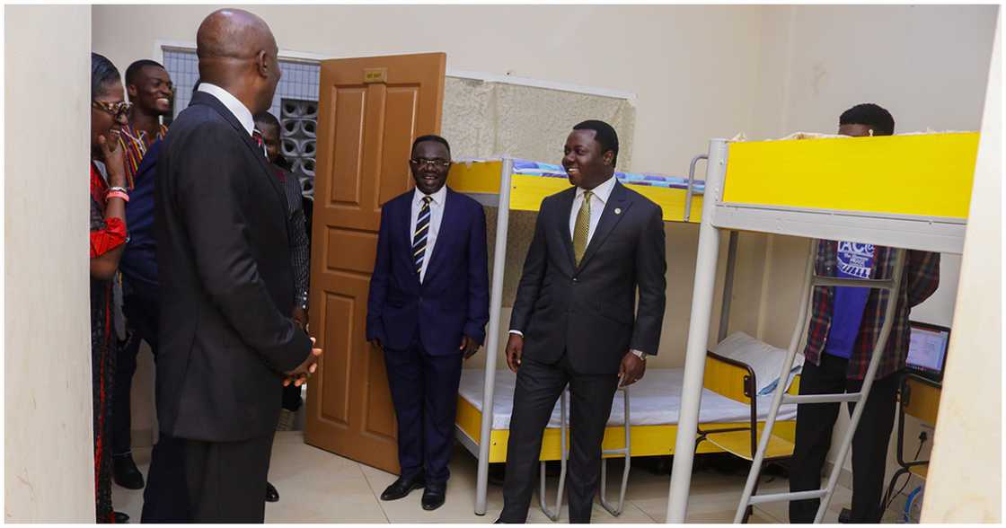 Mr. Fordjour inspects one of the rooms in the hostel