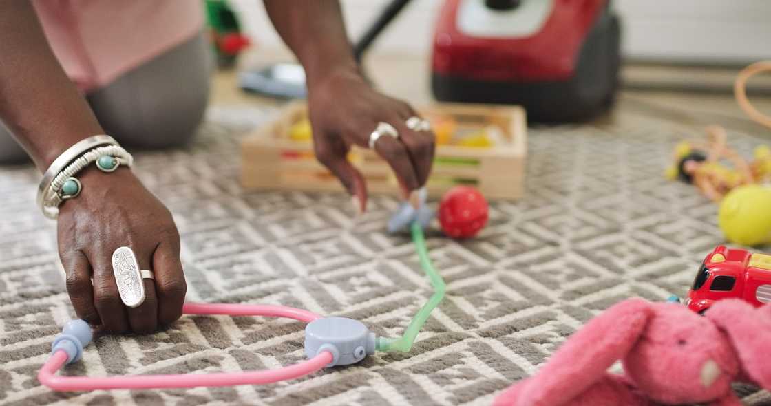 A black woman is cleaingn the playroom A black woman is cleaingn the playroom