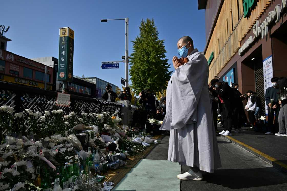 A Buddhist nun prays in tribute to the victims A Buddhist nun prays in tribute to the victims