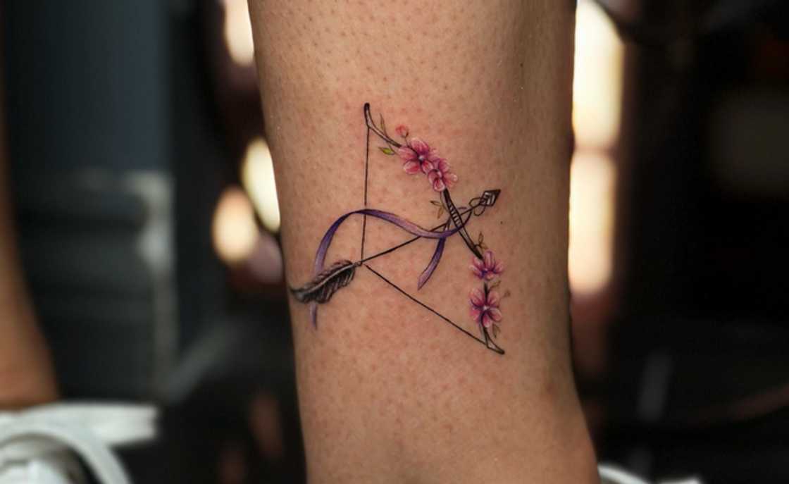 A feminine bow and arrow tattoo