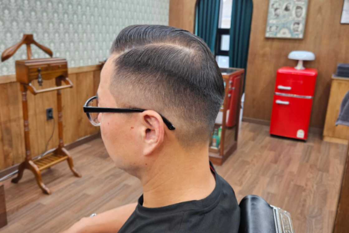 A man is rocking a pompadour hair