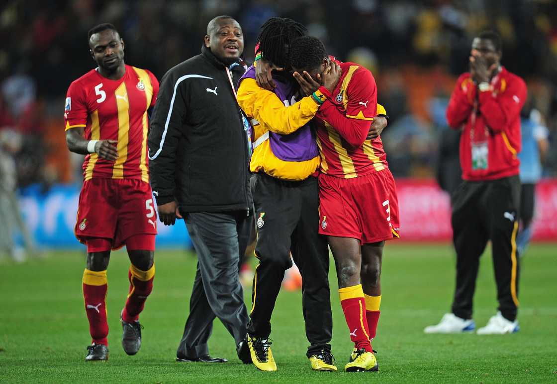 Asamoah Gyan of Ghana is consoled after his team are knocked out in a penalty shoot out during the 2010 FIFA World Cup South Africa Quarter Final match between Uruguay and Ghana at the Soccer City stadium on July 2, 2010 in Johannesburg, South Africa Asamoah Gyan of Ghana is consoled after his team are knocked out in a penalty shoot out during the 2010 FIFA World Cup South Africa Quarter Final match between Uruguay and Ghana at the Soccer City stadium on July 2, 2010 in Johannesburg, South Africa
