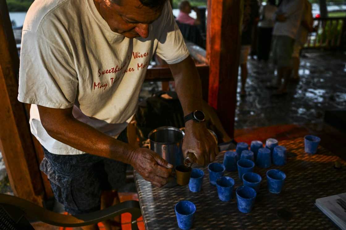 A member of the Royal Naval Tot Club pours rum at the waterfront Galley Bar in Antigua and Barbuda on September 17 A member of the Royal Naval Tot Club pours rum at the waterfront Galley Bar in Antigua and Barbuda on September 17