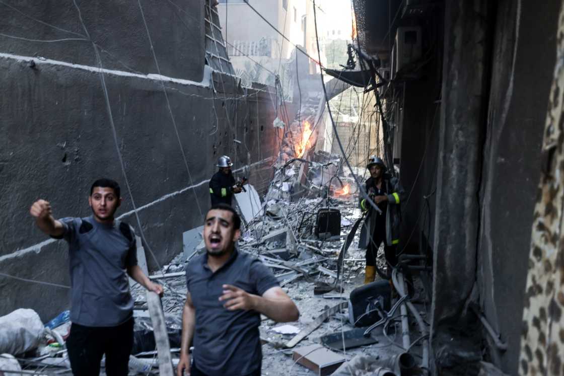 Palestinian firefighters battle a blaze sparked by an Israeli air strike on Gaza City Palestinian firefighters battle a blaze sparked by an Israeli air strike on Gaza City
