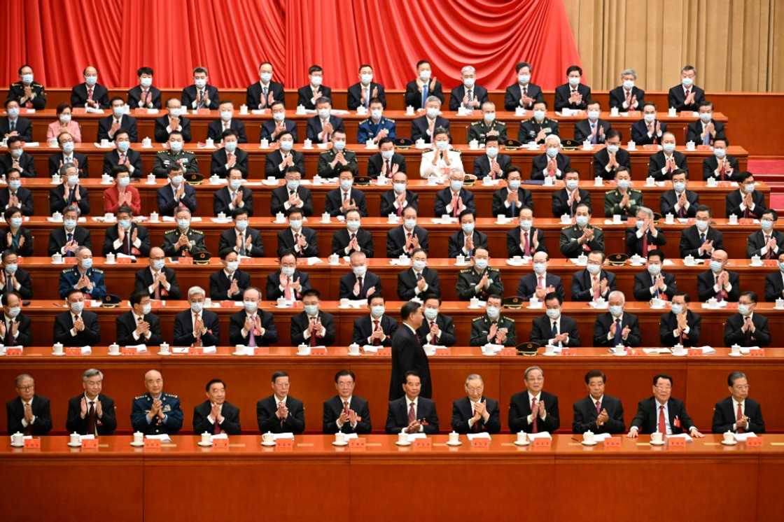 In line with strict health protocols, all those attending the Communist Party Congress were masked, apart from the front row of top-ranked guests In line with strict health protocols, all those attending the Communist Party Congress were masked, apart from the front row of top-ranked guests