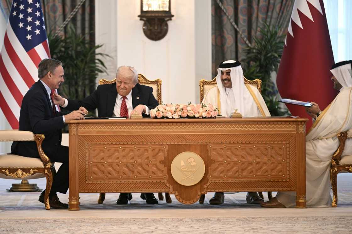 Boeing CEO Kelly Ortberg sits to the left of US President Donald Trump and Qatar's Emir Sheikh Tamim bin Hamad al-Thani (R) during a business deal signing ceremony at the Royal Palace in Doha, on May 14, 2025 Boeing CEO Kelly Ortberg sits to the left of US President Donald Trump and Qatar's Emir Sheikh Tamim bin Hamad al-Thani (R) during a business deal signing ceremony at the Royal Palace in Doha, on May 14, 2025