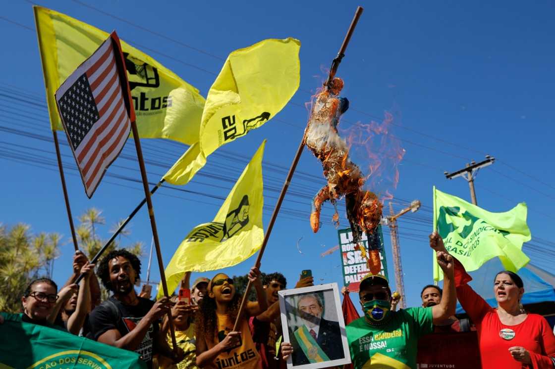 Demonstrators burn US President Donald Trump in effigy during a protest following his imposition of trade taxes and sanctions