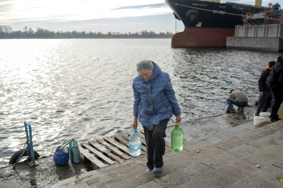 Local people are collecting water from the Dnipro river in Kherson,
now a natural dividing line between Ukraine's forces and Russians on the opposing bank Local people are collecting water from the Dnipro river in Kherson,
now a natural dividing line between Ukraine's forces and Russians on the opposing bank