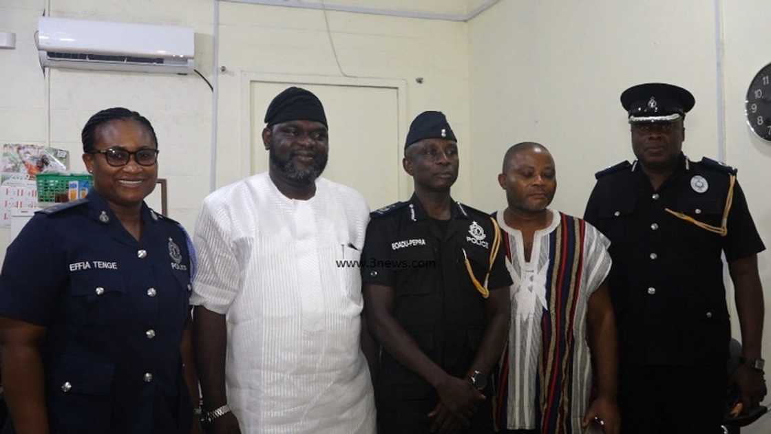 A group of people posing for a photograph A group of people posing for a photograph