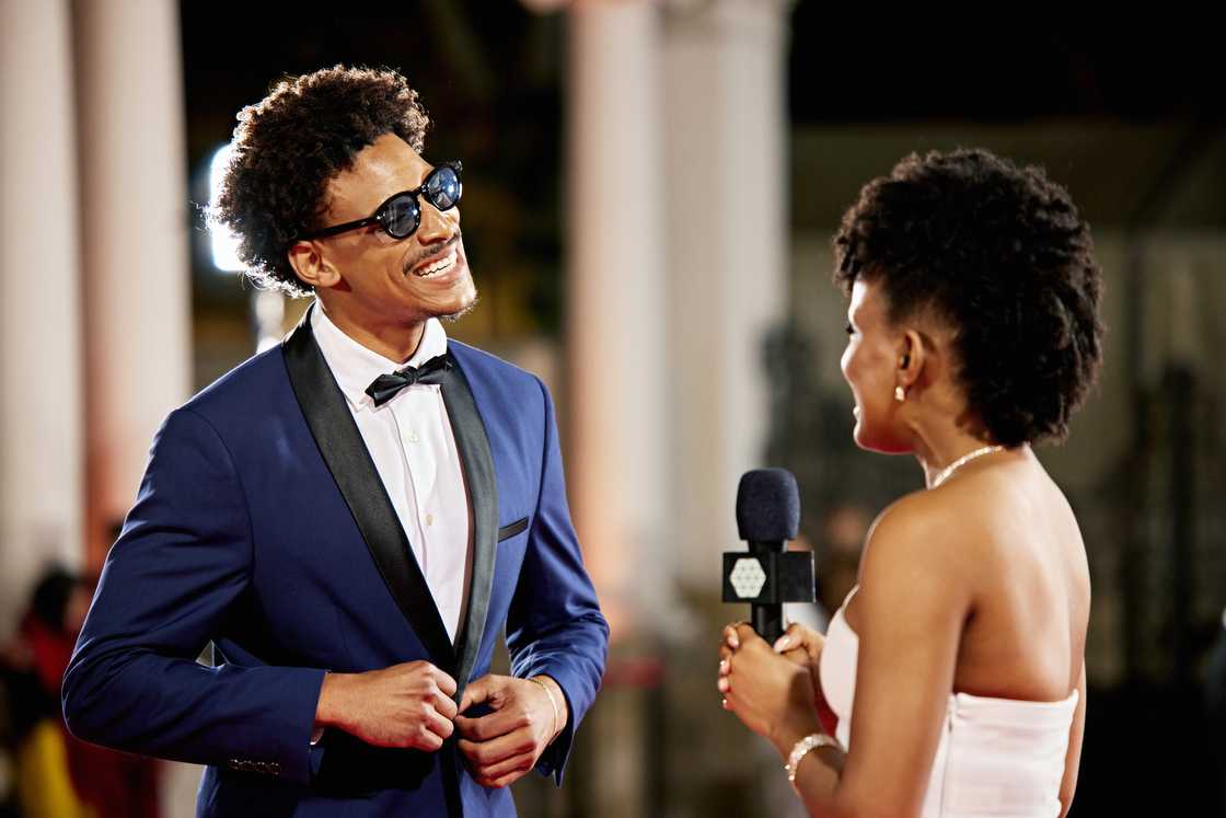 A man talking to a journalist