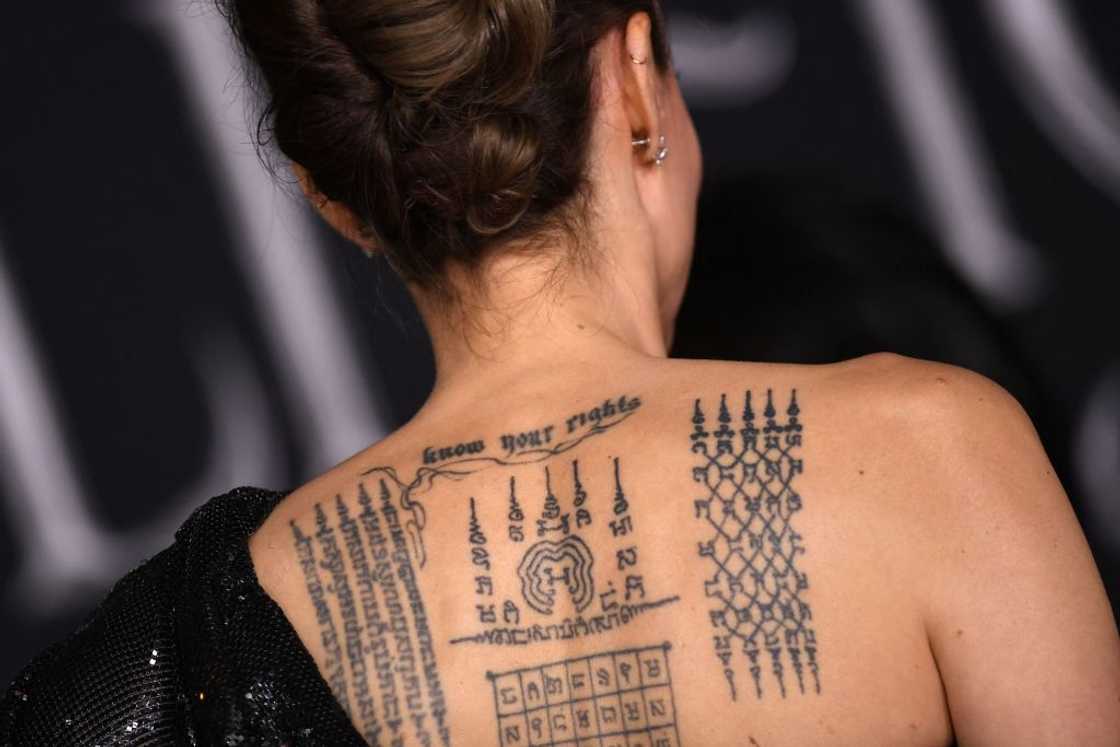 Angelina Jolie's tattoos are seen as she arrives for the world premiere of Disney's "Maleficent: Mistress of Evil" at the El Capitan Theatre in Hollywood Angelina Jolie's tattoos are seen as she arrives for the world premiere of Disney's "Maleficent: Mistress of Evil" at the El Capitan Theatre in Hollywood