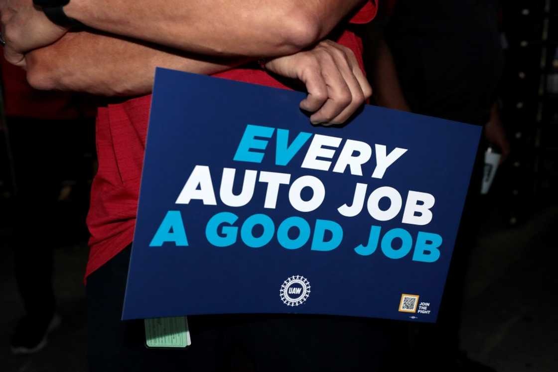 United Auto Workers members hold signs outside the Stellantis auto plant in Sterling Heights, Michigan, on July 12, 2023 United Auto Workers members hold signs outside the Stellantis auto plant in Sterling Heights, Michigan, on July 12, 2023