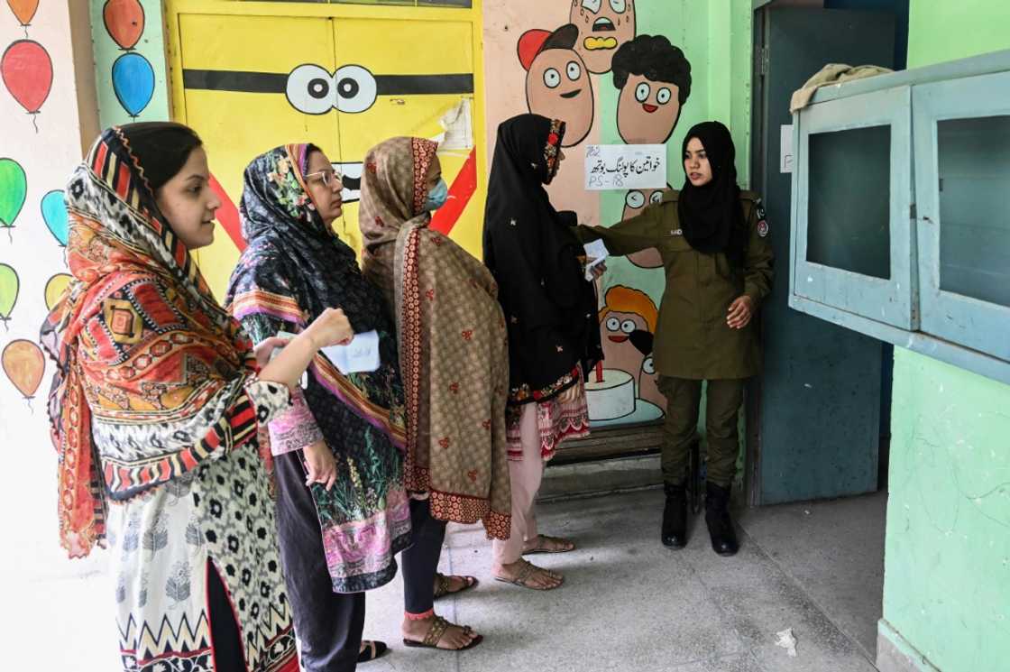 Women line up to cast their ballots in the Punjab province assembly by-election Women line up to cast their ballots in the Punjab province assembly by-election
