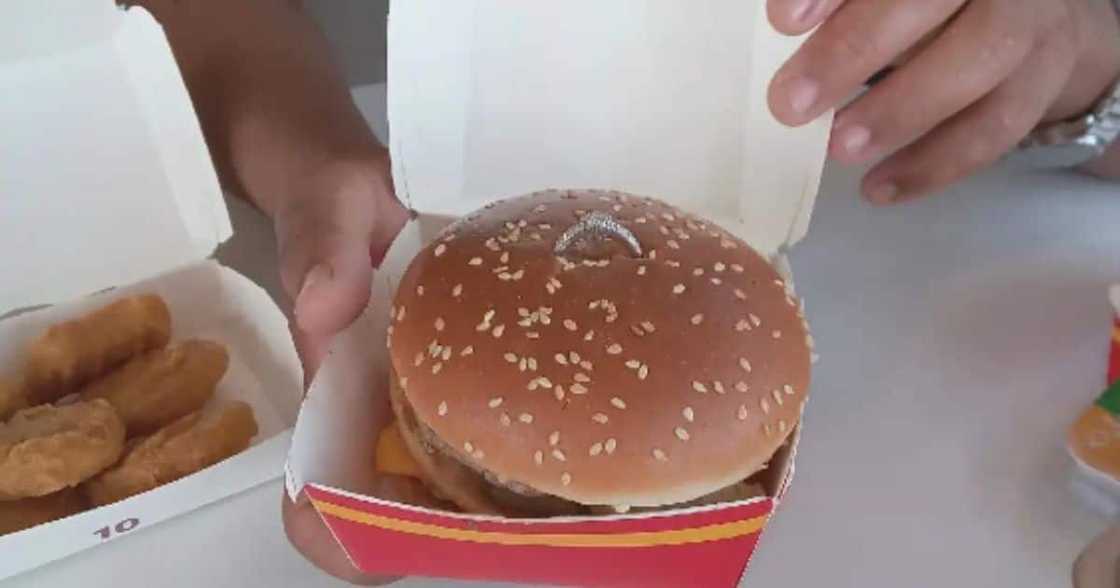 A gentleman proposed to his woman at McD's with a burger. A gentleman proposed to his woman at McD's with a burger.