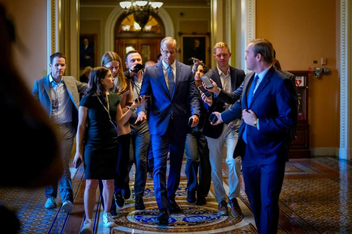 US Senate Majority Leader John Thune speaks to reporters as returns to his office from the Senate Chamber at the U.S. Capitol Building