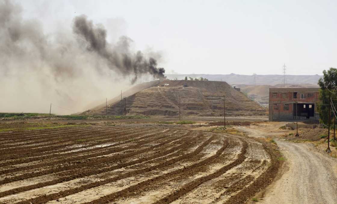 Smoke billows over the village of Altrun Kupri, in the Sherawa region, south of Arbil in Iraq's Kurdistan, where a base of the Kurdistan Freedom Party is located, on September 28, 2022