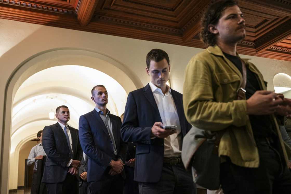 Sons of defendant Ian Lundin, William Lundin (L), Harry Lundin (2nd L) and Jack Lundin (2nd R), attended the opening day of the trial in Stockholm's District Court