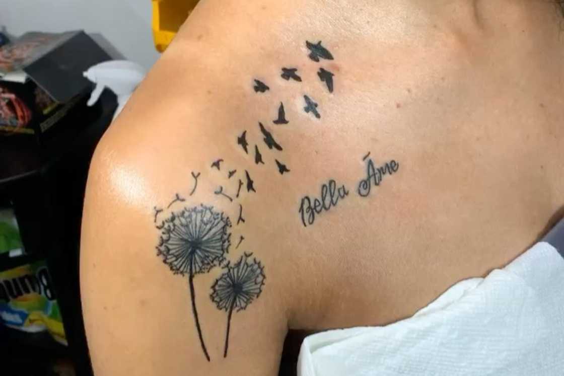 Dandelions with doves shoulder tattoo Dandelions with doves shoulder tattoo
