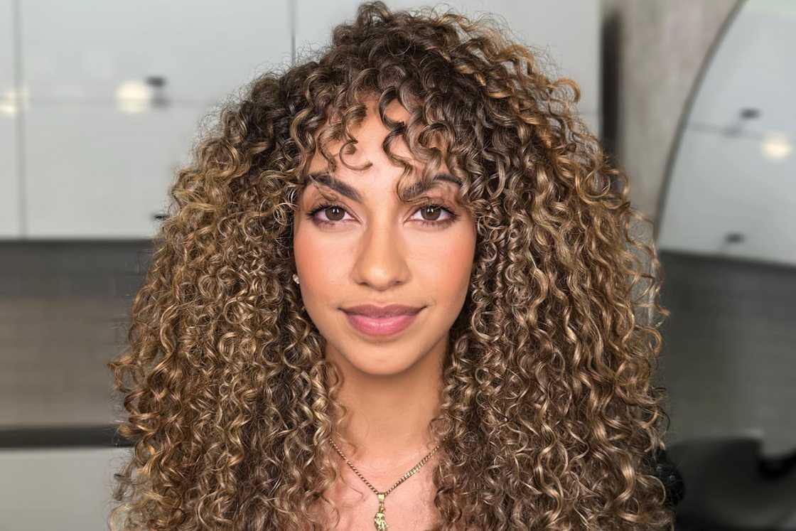 A lady with curly blonde