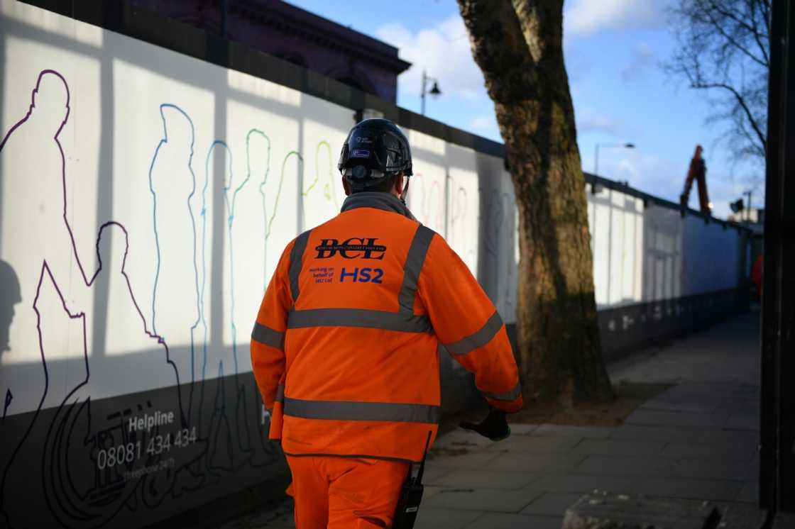 A construction worker walks outside a construction site for a section of Britain's HS2 high-speed railway project at London Euston train station A construction worker walks outside a construction site for a section of Britain's HS2 high-speed railway project at London Euston train station