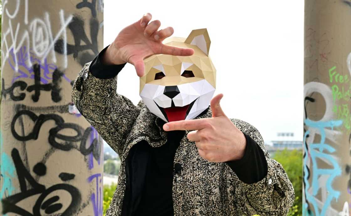Tridog, a member of Own the Doge, wears a Doge mask as he poses for photos during an interview in Los Angeles Tridog, a member of Own the Doge, wears a Doge mask as he poses for photos during an interview in Los Angeles