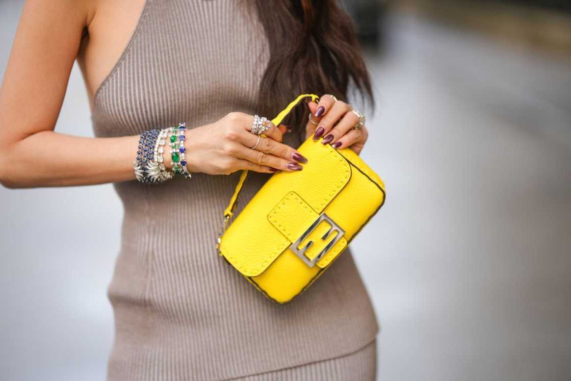 Heart Evangelista wears a yellow Fendi bag. Heart Evangelista wears a yellow Fendi bag.