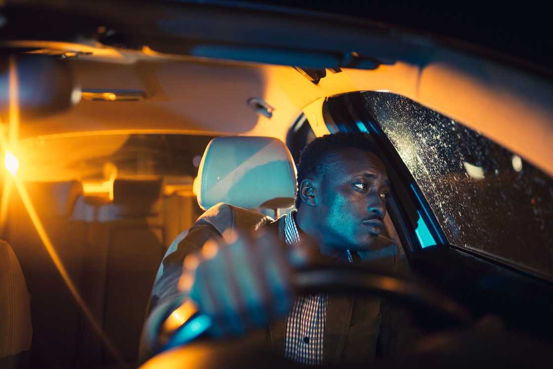 A drunk man in a car at night A drunk man in a car at night