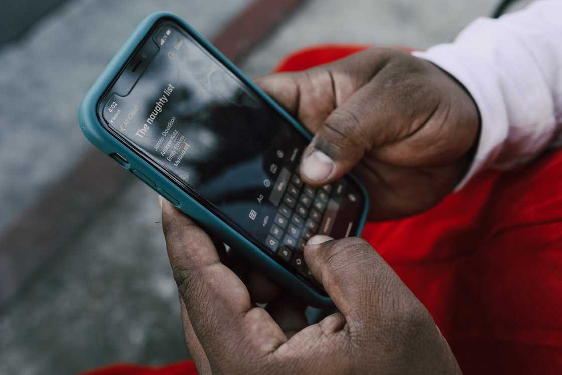 A person adds people to his phone's naughty list. A person adds people to his phone's naughty list.