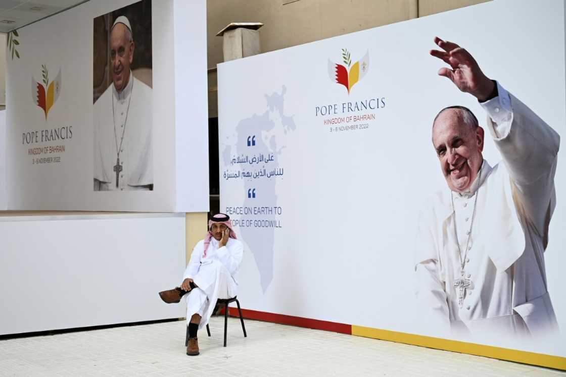 A man waits for the arrival of Pope Francis at Sacred Heart Church, the oldest in the Gulf