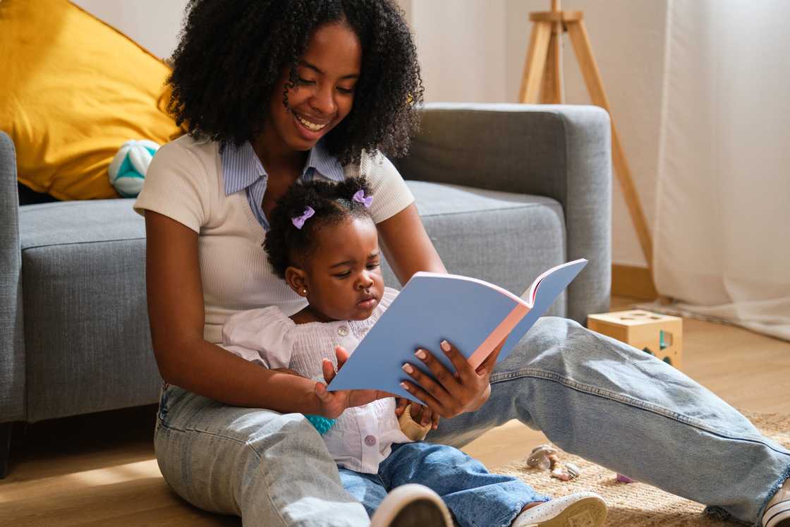 A nanny read a book to a toddler