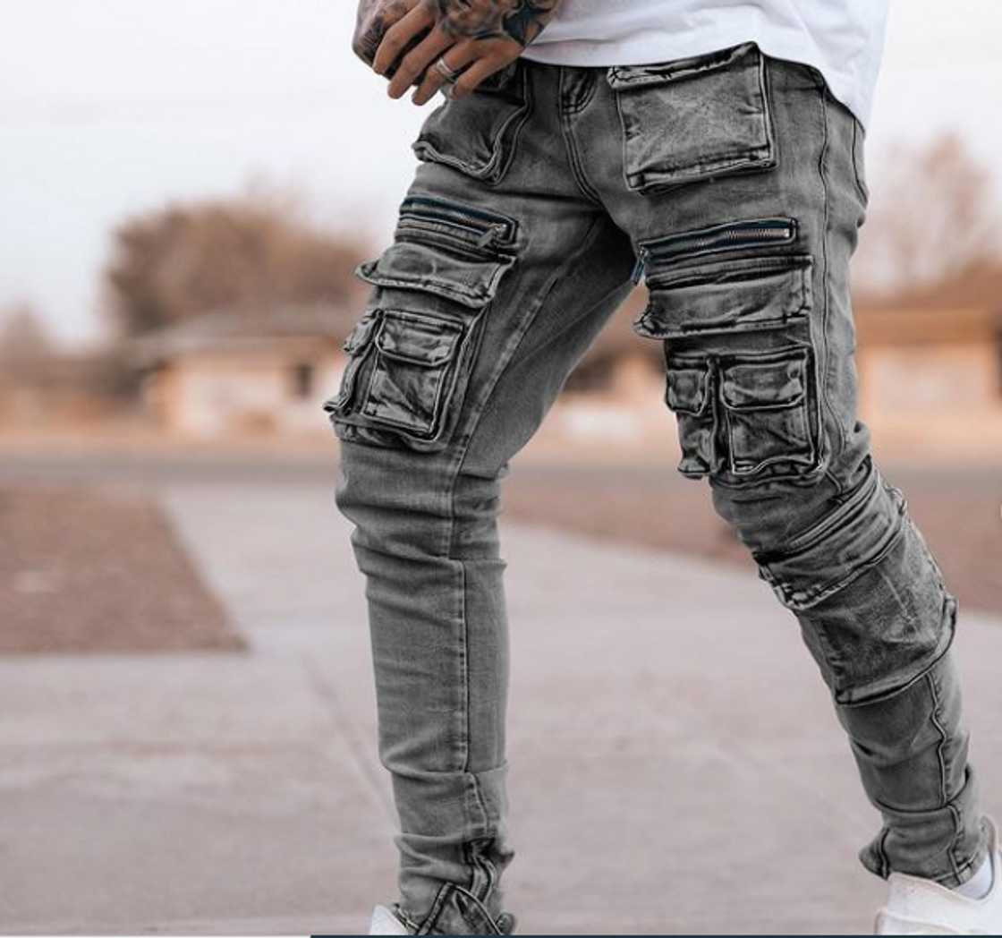 A young man in denim cargo pants A young man in denim cargo pants