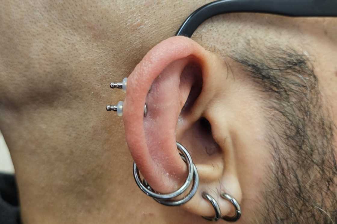 Double conch and double helix piercing Double conch and double helix piercing