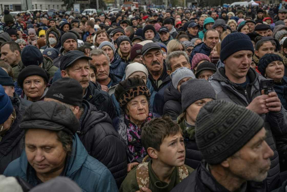 Local residents wait at a food distribution center in Kherson