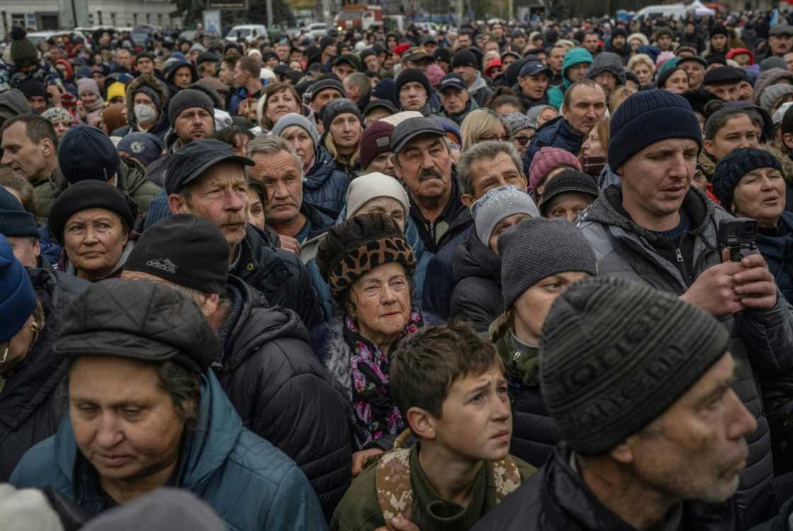Local residents wait at a food distribution center in Kherson Local residents wait at a food distribution center in Kherson