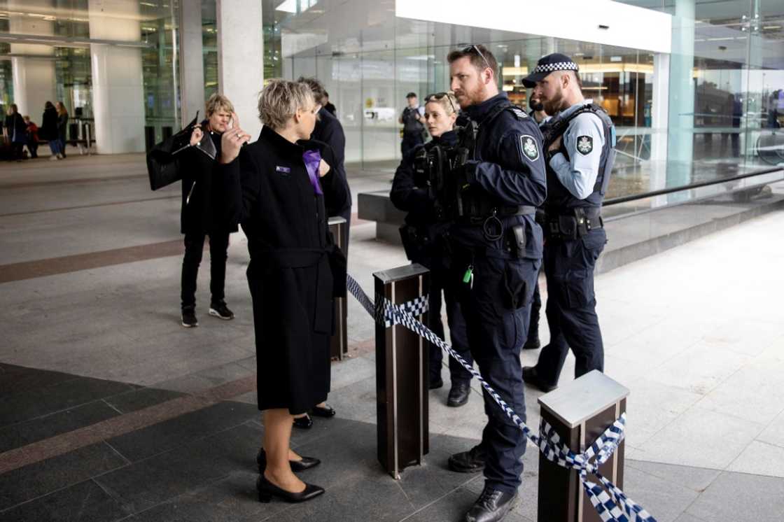 A gunman fired around five shots inside Canberra's main airport Sunday, sending passengers fleeing but injuring no one before he was detained by police