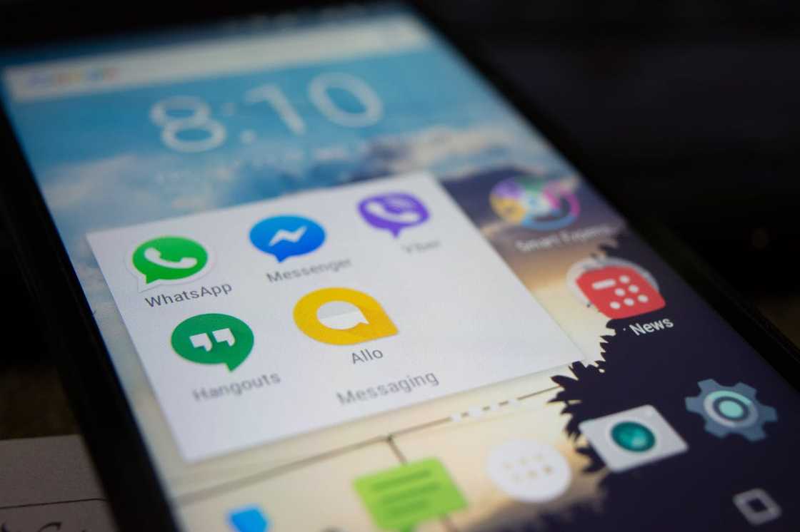 Messaging apps appear on a smartphone screen. Messaging apps appear on a smartphone screen.