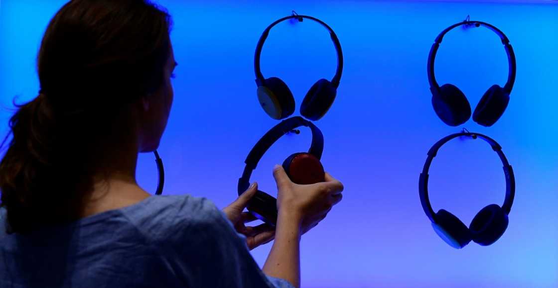 A woman poses at an installation showing headphones at the booth of JVC at the IFA (Internationale Funkausstellung) electronics trade fair in Berlin on September 1, 2016 A woman poses at an installation showing headphones at the booth of JVC at the IFA (Internationale Funkausstellung) electronics trade fair in Berlin on September 1, 2016