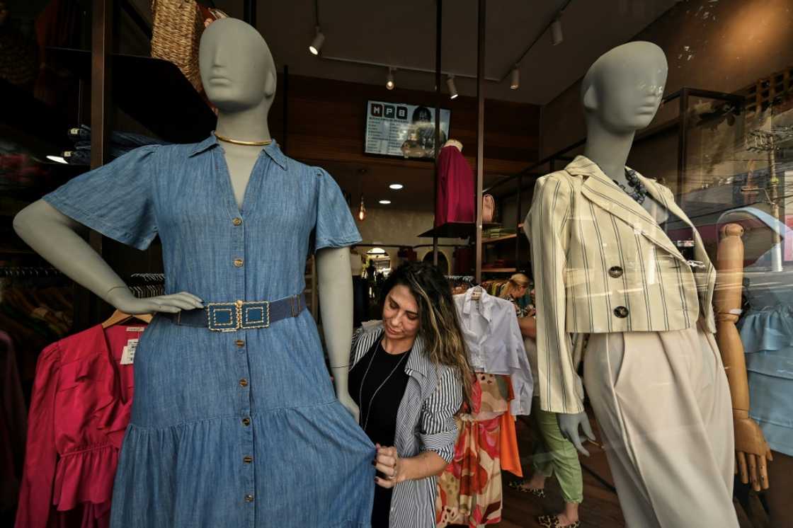 A saleswoman dresses a plus size mannequin at a store in Sao Paulo, Brazil A saleswoman dresses a plus size mannequin at a store in Sao Paulo, Brazil