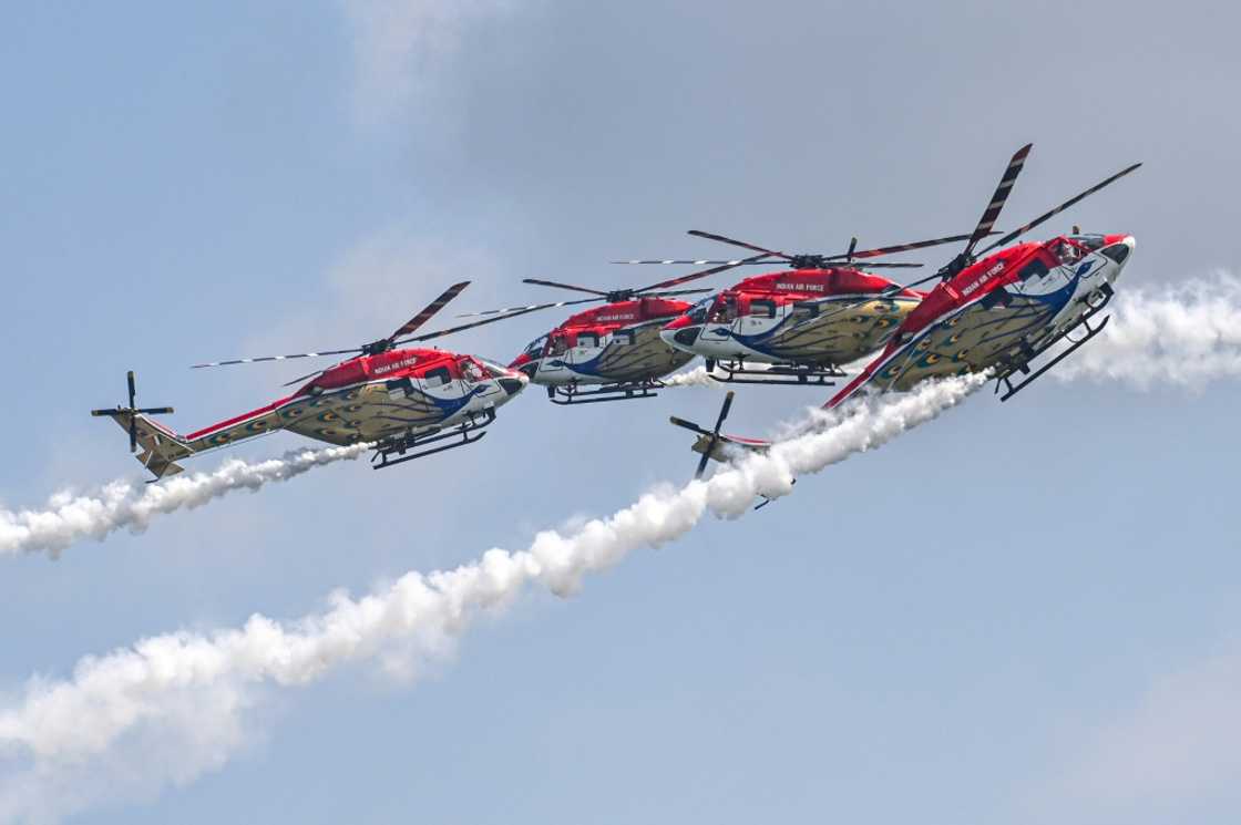 Members of the Sarang Helicopter Display Team of the Indian Air Force (IAF) perform with modified HAL Dhruv helicopters, also known as Advanced Light Helicopter (ALH), during a preview of the Singapore Airshow in Singapore on February 18, 2024 Members of the Sarang Helicopter Display Team of the Indian Air Force (IAF) perform with modified HAL Dhruv helicopters, also known as Advanced Light Helicopter (ALH), during a preview of the Singapore Airshow in Singapore on February 18, 2024