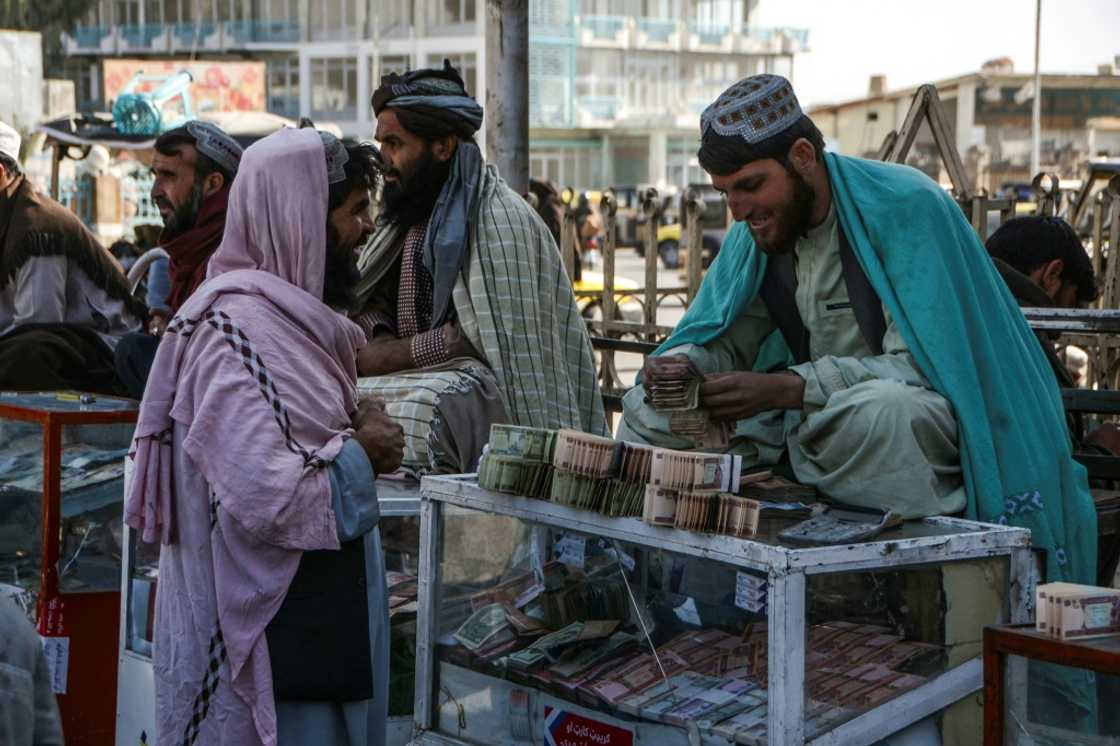 A money changer counts Afghani banknotes at an exchange market in Kandahar in December 2021 amid the sidelining of the country's central bank by global powers following the Taliban's return to power A money changer counts Afghani banknotes at an exchange market in Kandahar in December 2021 amid the sidelining of the country's central bank by global powers following the Taliban's return to power