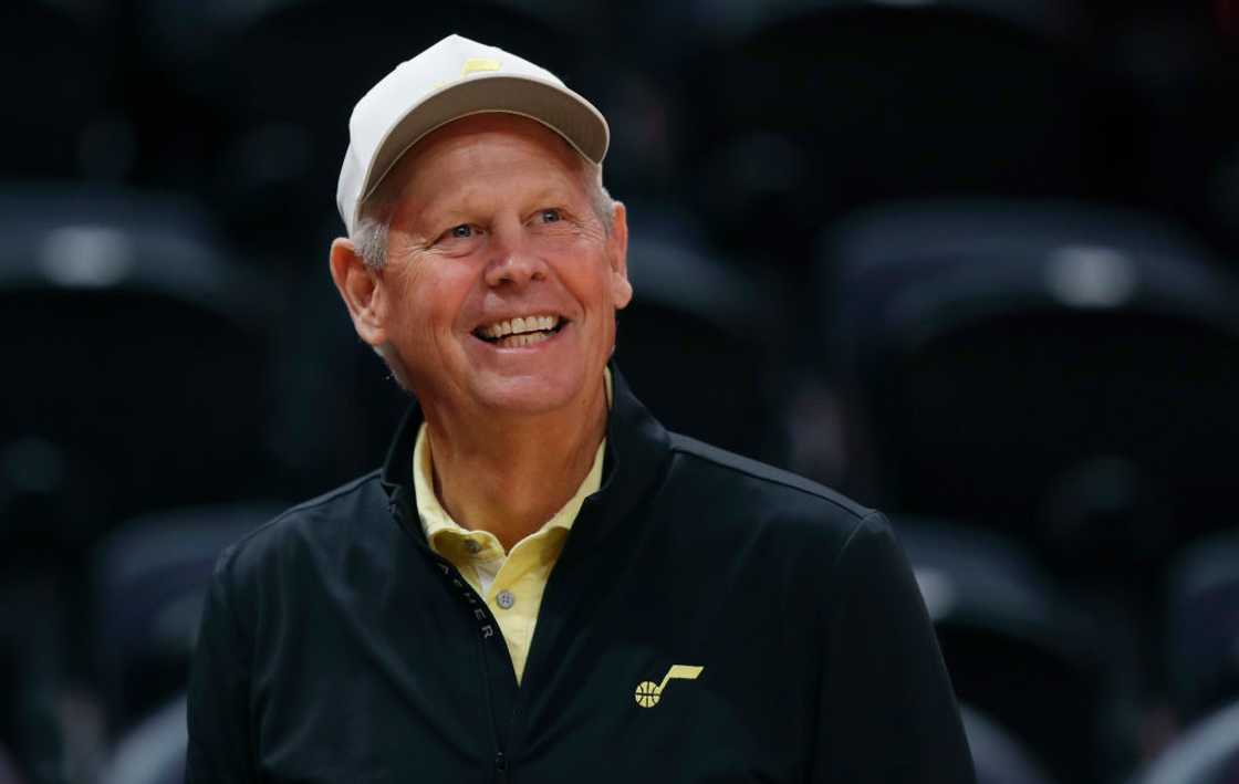 Danny Ainge in a white cap and yellow t-shirt