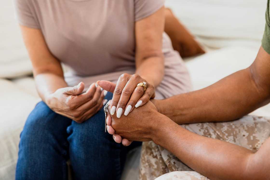 A man and woman hoding hands