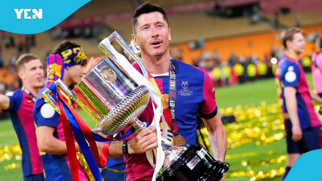 Robert Lewandowski centre-forward of Barcelona and Poland celebrates with the trophy after winning the Copa del Rey Final match between FC Barcelona and Real Madrid at Estadio de La Cartuja on April 26, 2025 Robert Lewandowski centre-forward of Barcelona and Poland celebrates with the trophy after winning the Copa del Rey Final match between FC Barcelona and Real Madrid at Estadio de La Cartuja on April 26, 2025